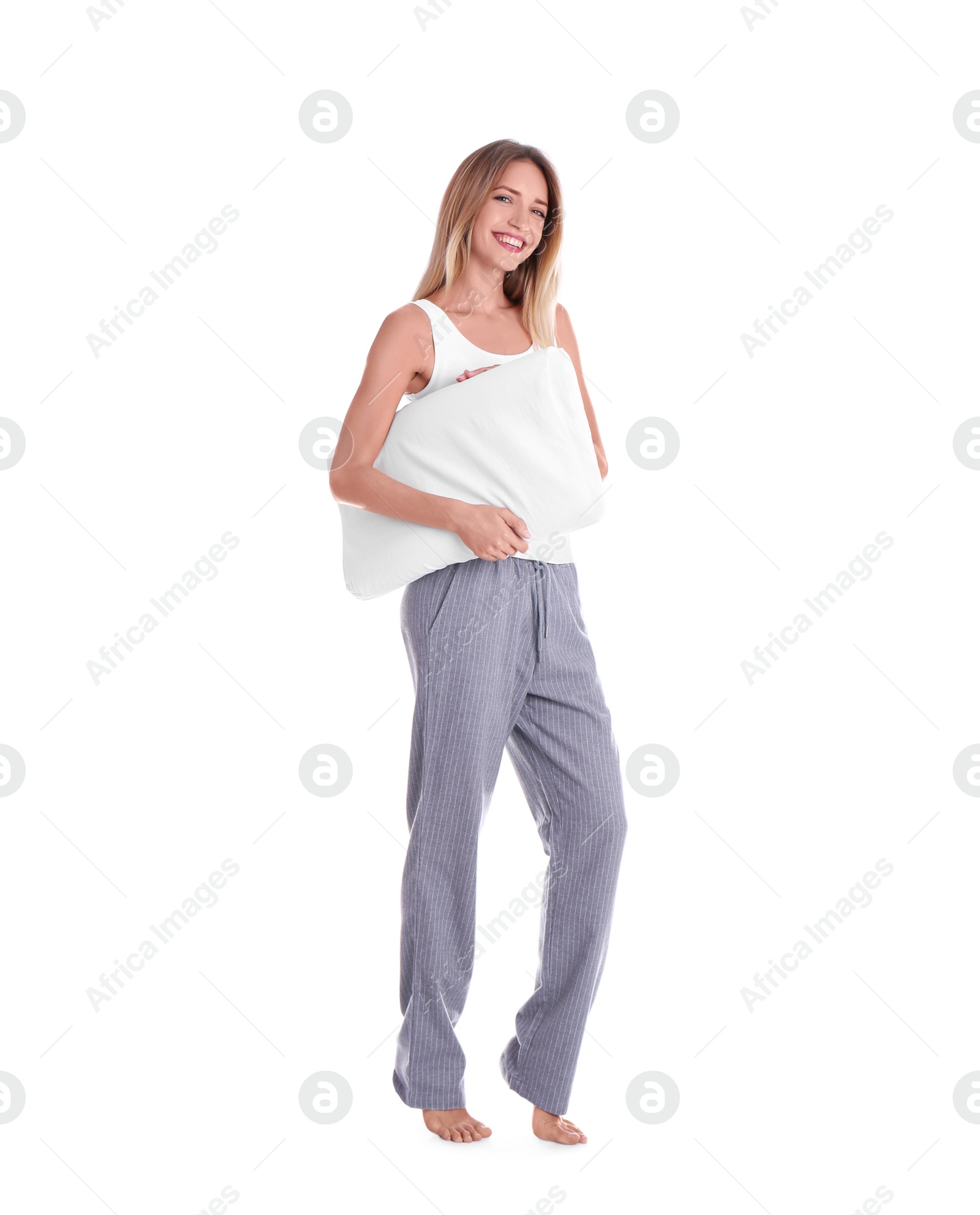 Photo of Happy woman in pajamas with pillow on white background