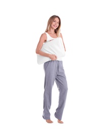 Happy woman in pajamas with pillow on white background