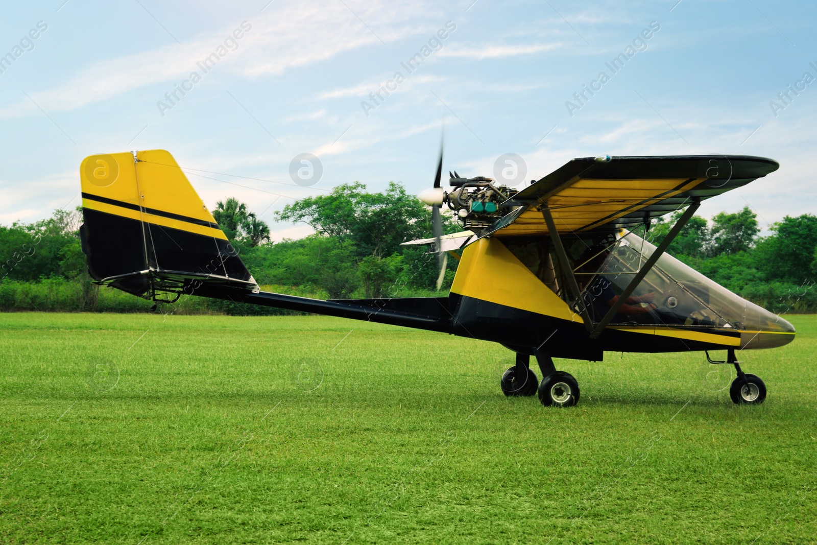 Photo of Modern light aircraft on green grass outdoors