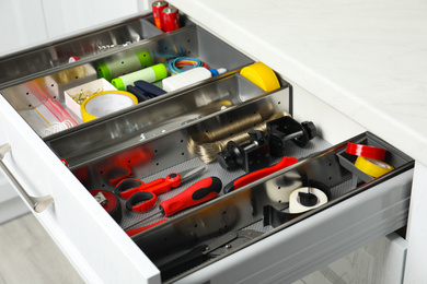 Set of instruments in open desk drawer indoors