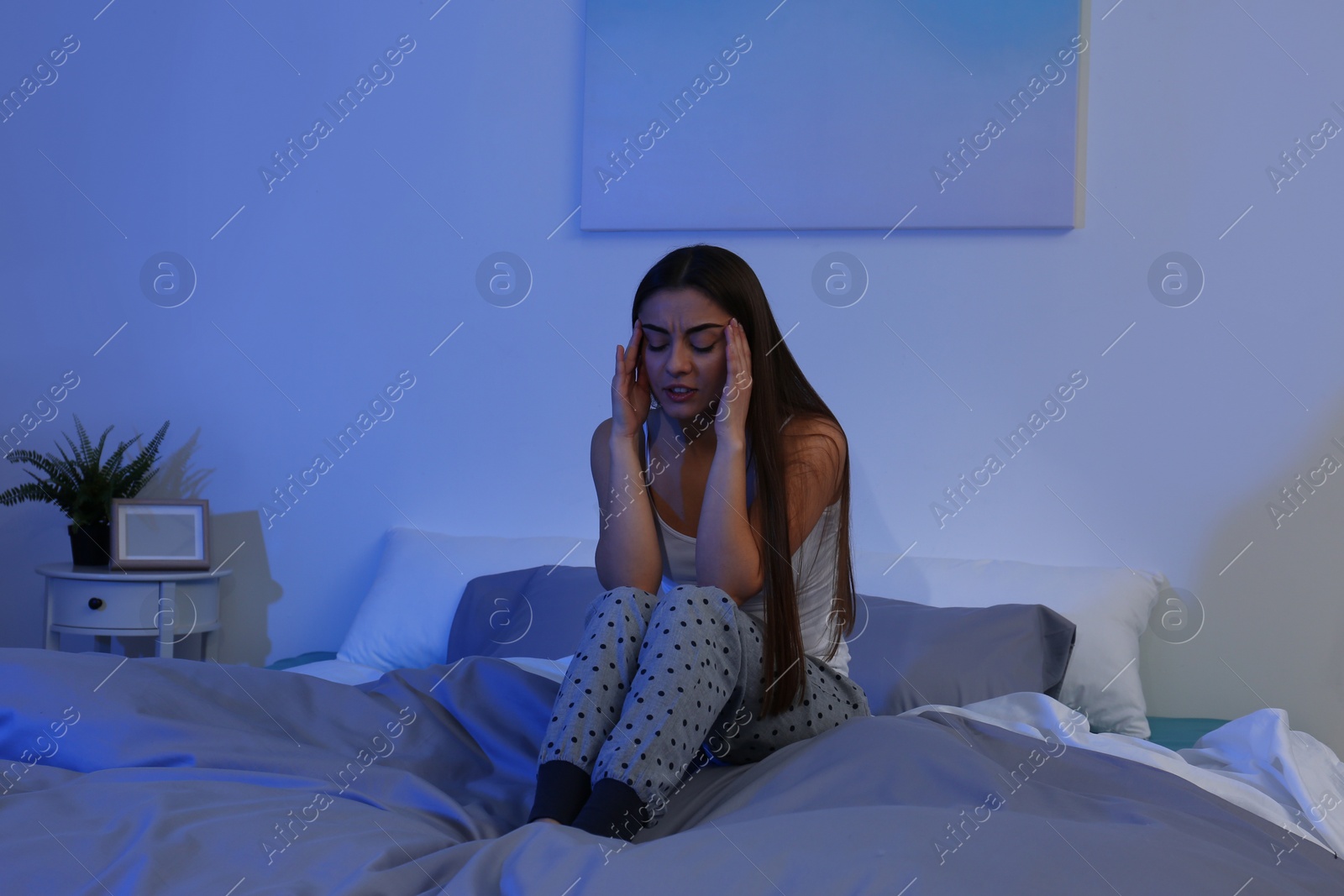 Photo of Young woman suffering from insomnia at home. Bedtime