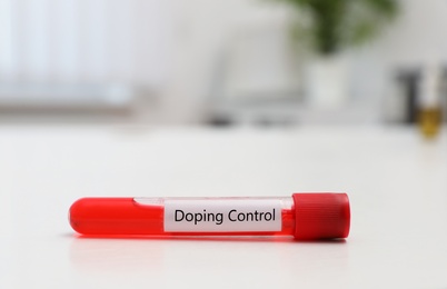 Image of Test tube with sample on white table. Doping control