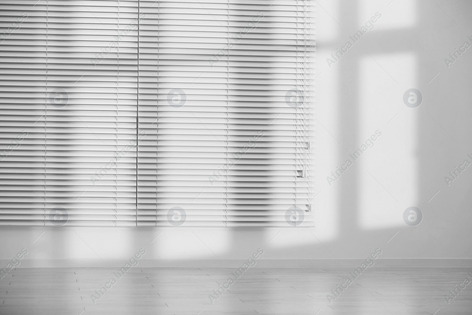 Photo of Light and shadows from window on wall indoors