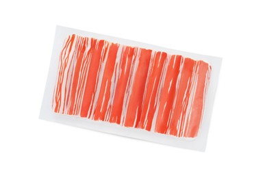 Photo of Delicious crab sticks in plastic packaging isolated on white, top view