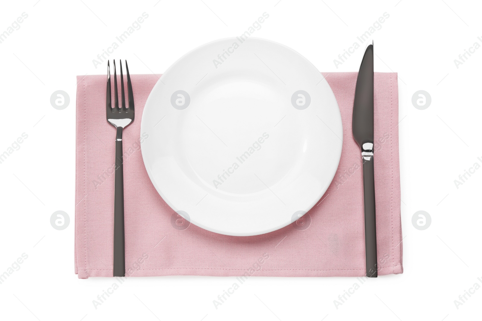 Photo of Clean plate and shiny silver cutlery on white table, flat lay