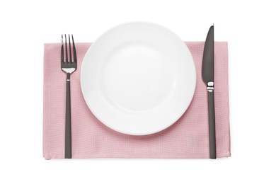 Photo of Clean plate and shiny silver cutlery on white table, flat lay