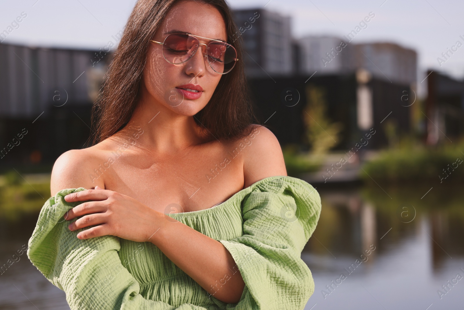 Photo of Beautiful woman in sunglasses near river, space for text