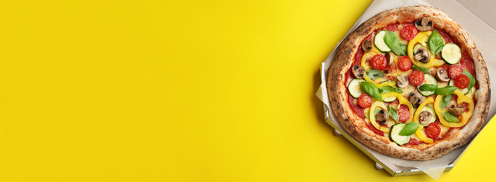 Image of Top viewhot delicious pizza on yellow background, space for text. Banner design 