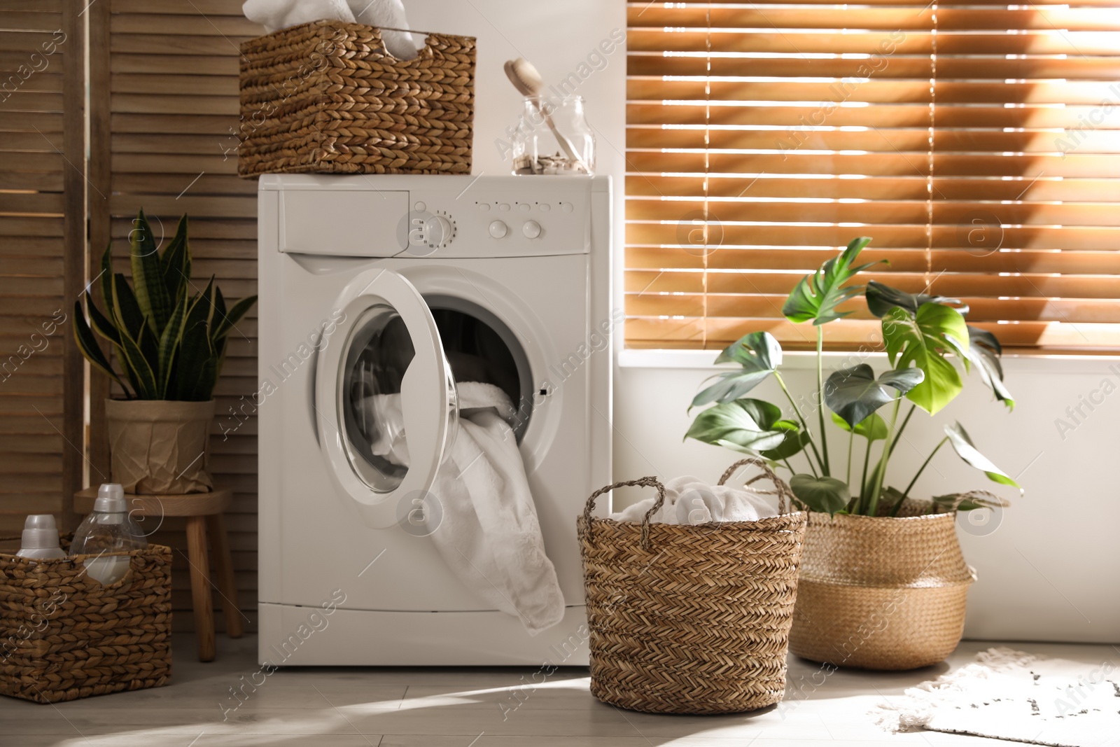 Photo of Stylish room interior with washing machine. Design idea