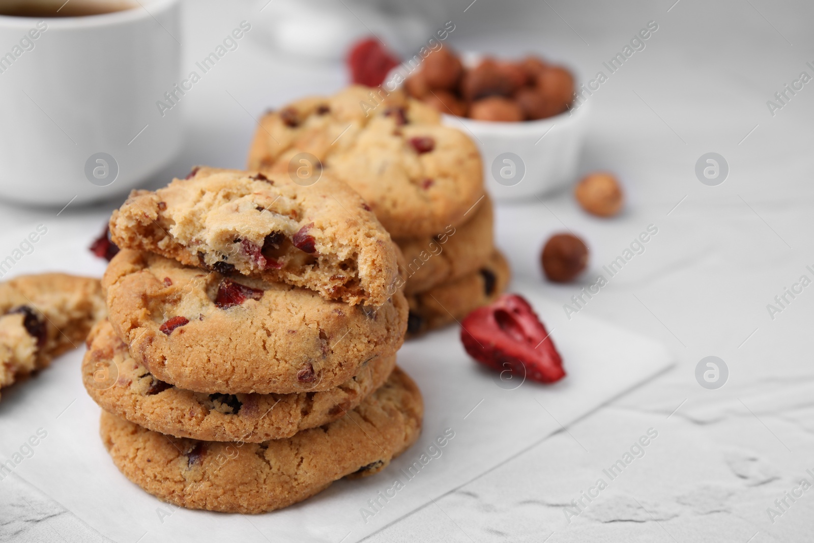 Cookies with freeze dried fruits and nuts on white textured table, closeup. Space for text Photo of Cookies with freeze dried fruits and nuts on white textured table, closeup. Space for text