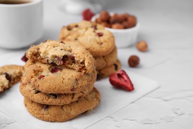 Photo of Cookies with freeze dried fruits and nuts on white textured table, closeup. Space for text