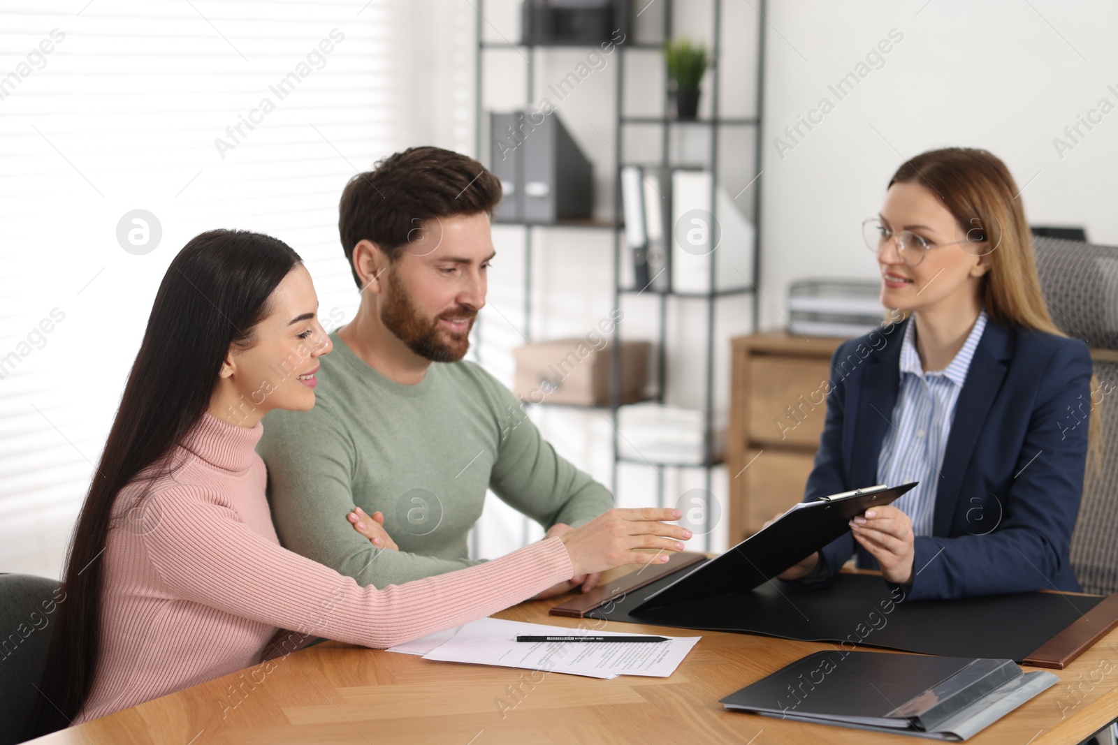 Photo of Couple having meeting with lawyer in office