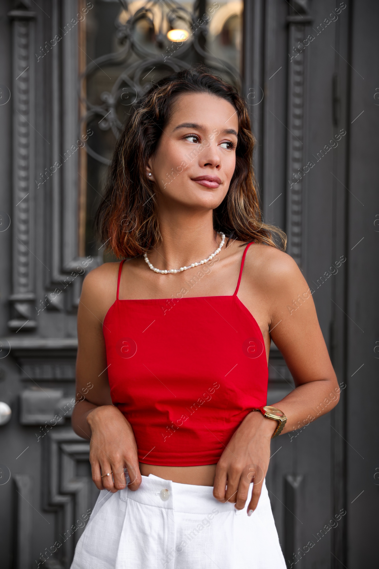 Photo of Portrait of beautiful young woman near vintage door outdoors