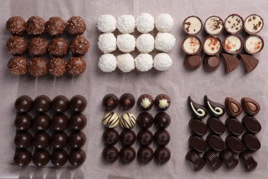 Photo of Many delicious chocolate candies on table, flat lay. Production line