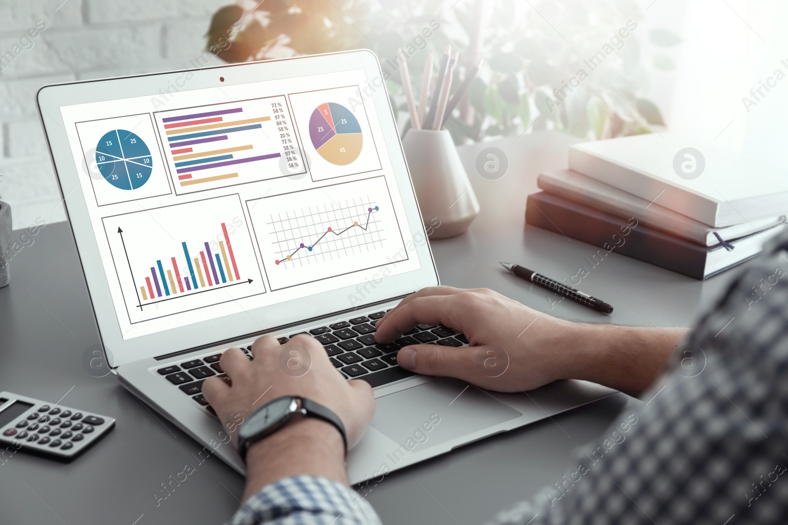 Image of Man working with laptop at table, closeup. Business analytics