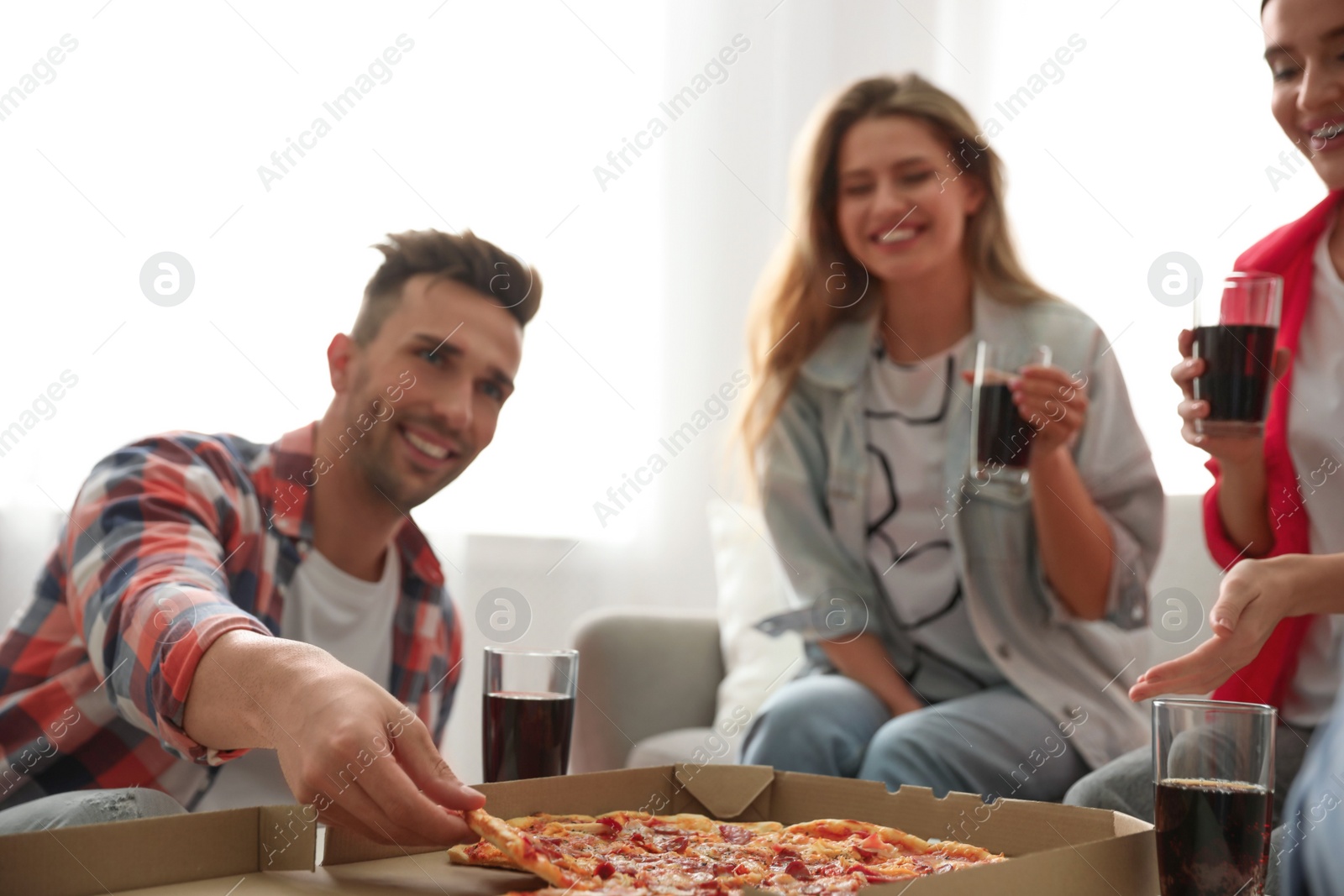 Photo of Group of friends eating tasty pizza at home