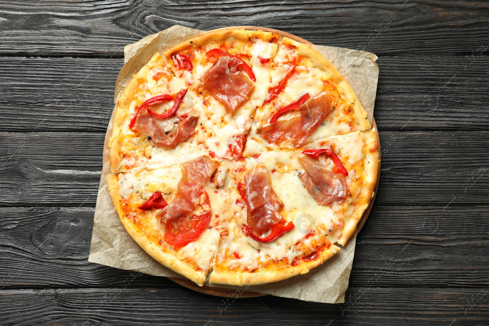 Photo of Delicious pizza with meat on wooden background, top view