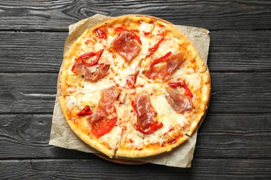 Delicious pizza with meat on wooden background, top view