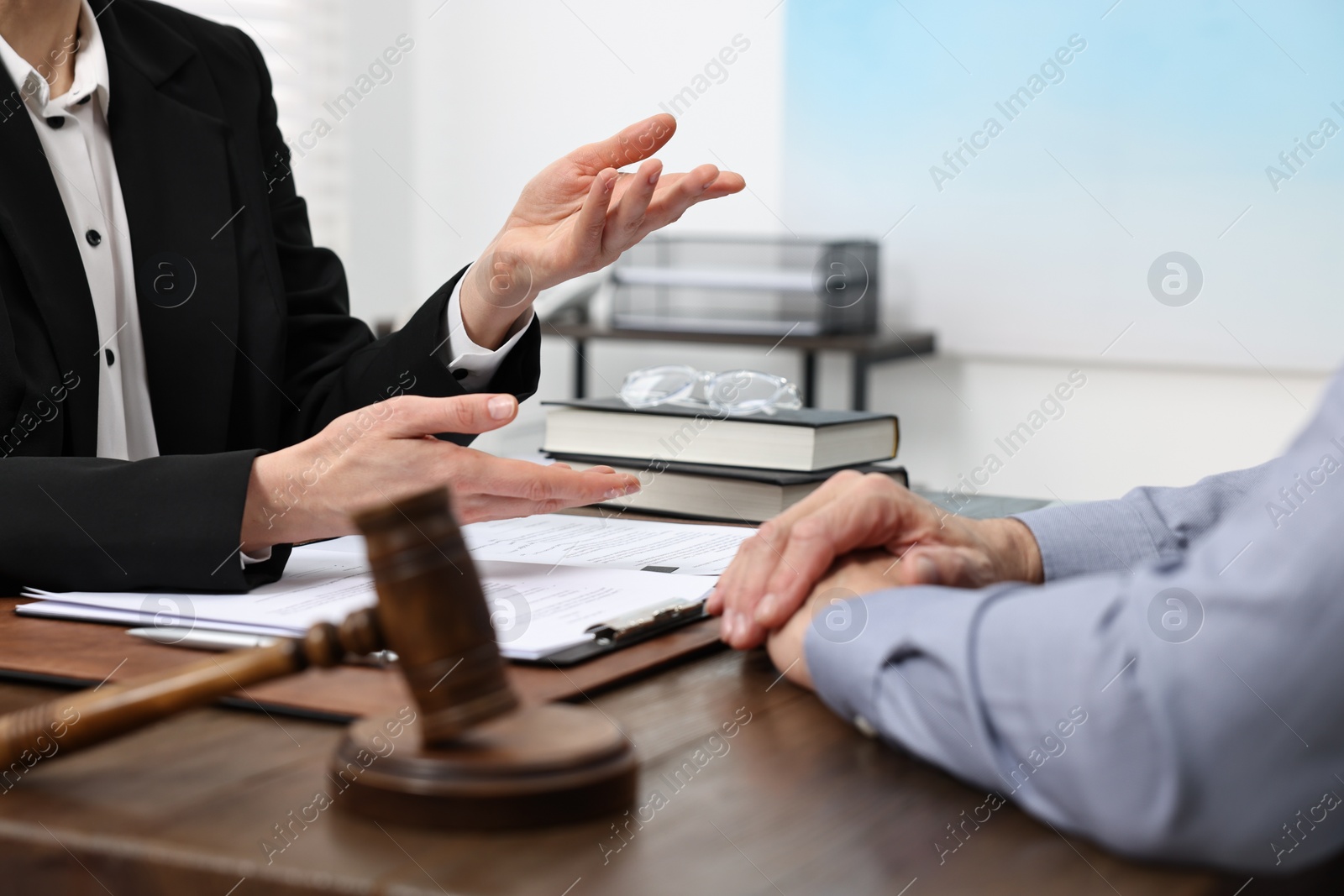 Photo of Senior man having meeting with lawyer in office, closeup