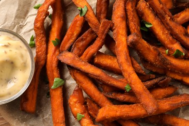 Photo of Delicious sweet potato fries and sauce, closeup