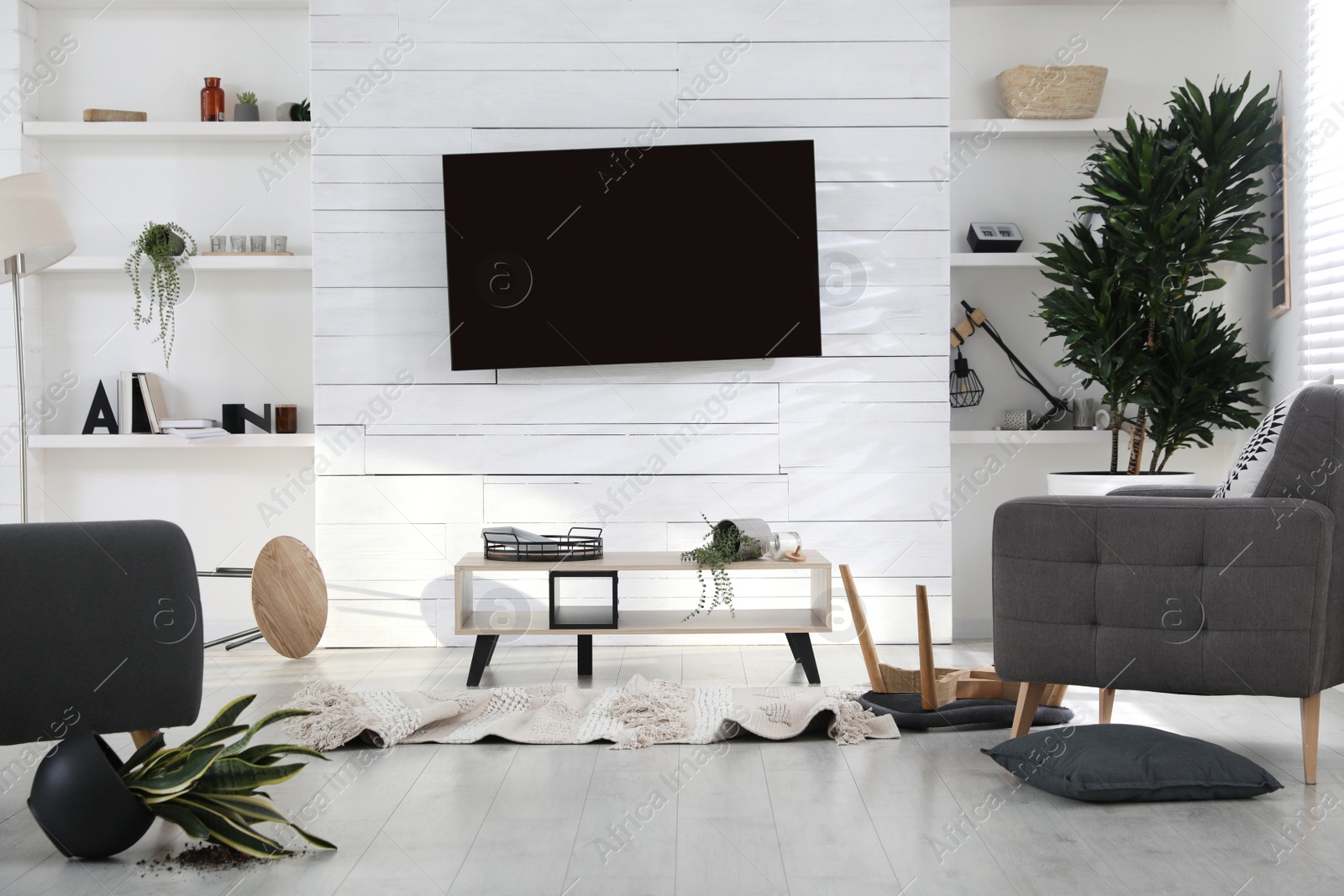 Photo of Chaotic living room interior after strong earthquake