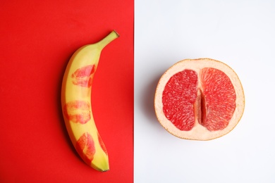 Photo of Flat lay composition with fresh banana and grapefruit on color background. Sex concept