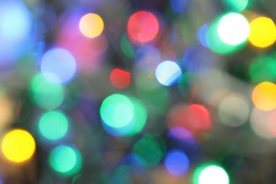 Photo of Blurred view of glowing Christmas lights as background
