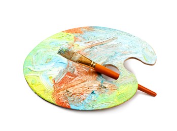 Photo of Artist's palette with mixed paints and brush isolated on white