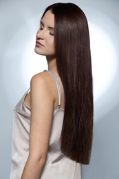 Beautiful young woman with healthy strong hair posing in studio