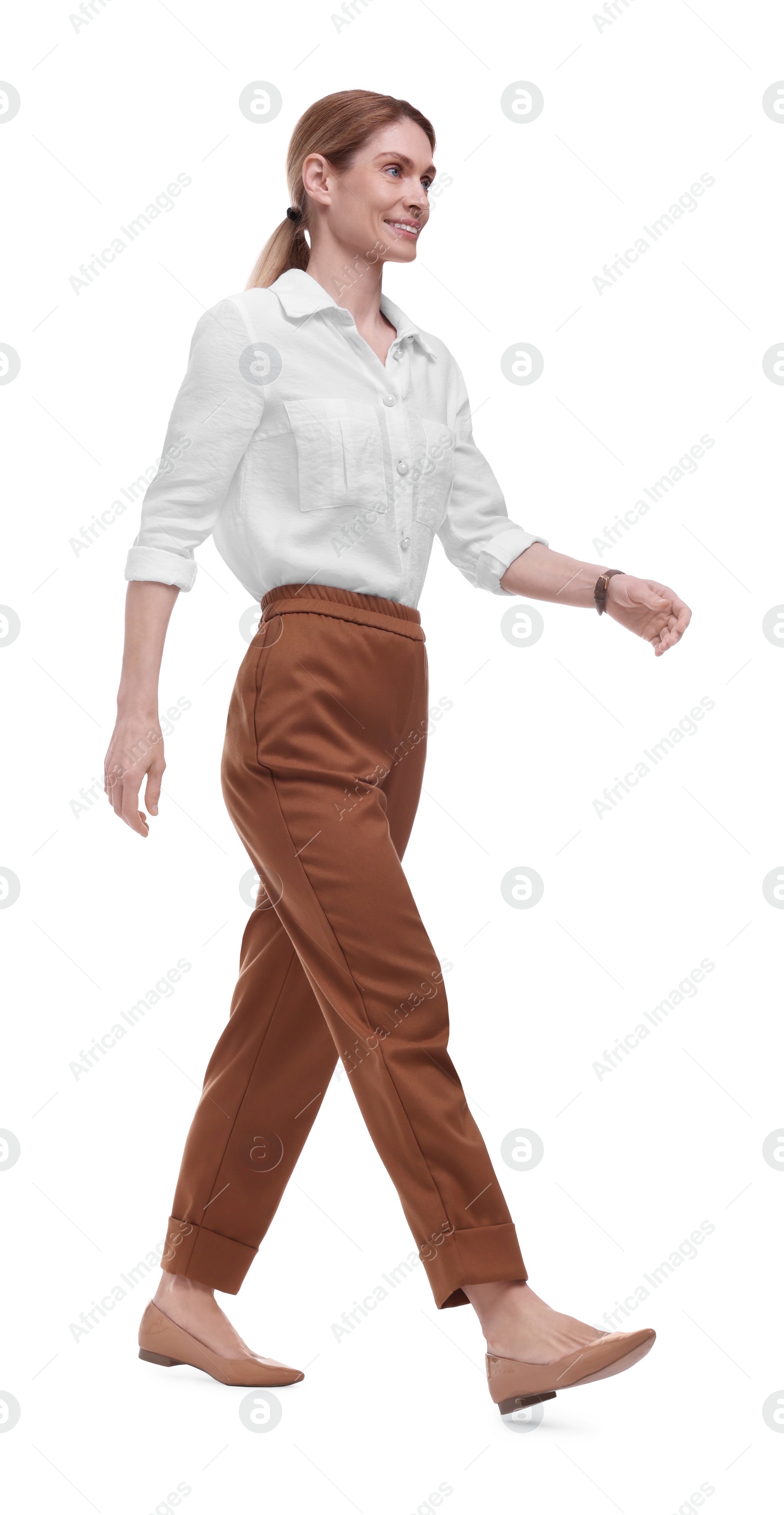 Photo of Beautiful happy businesswoman walking on white background