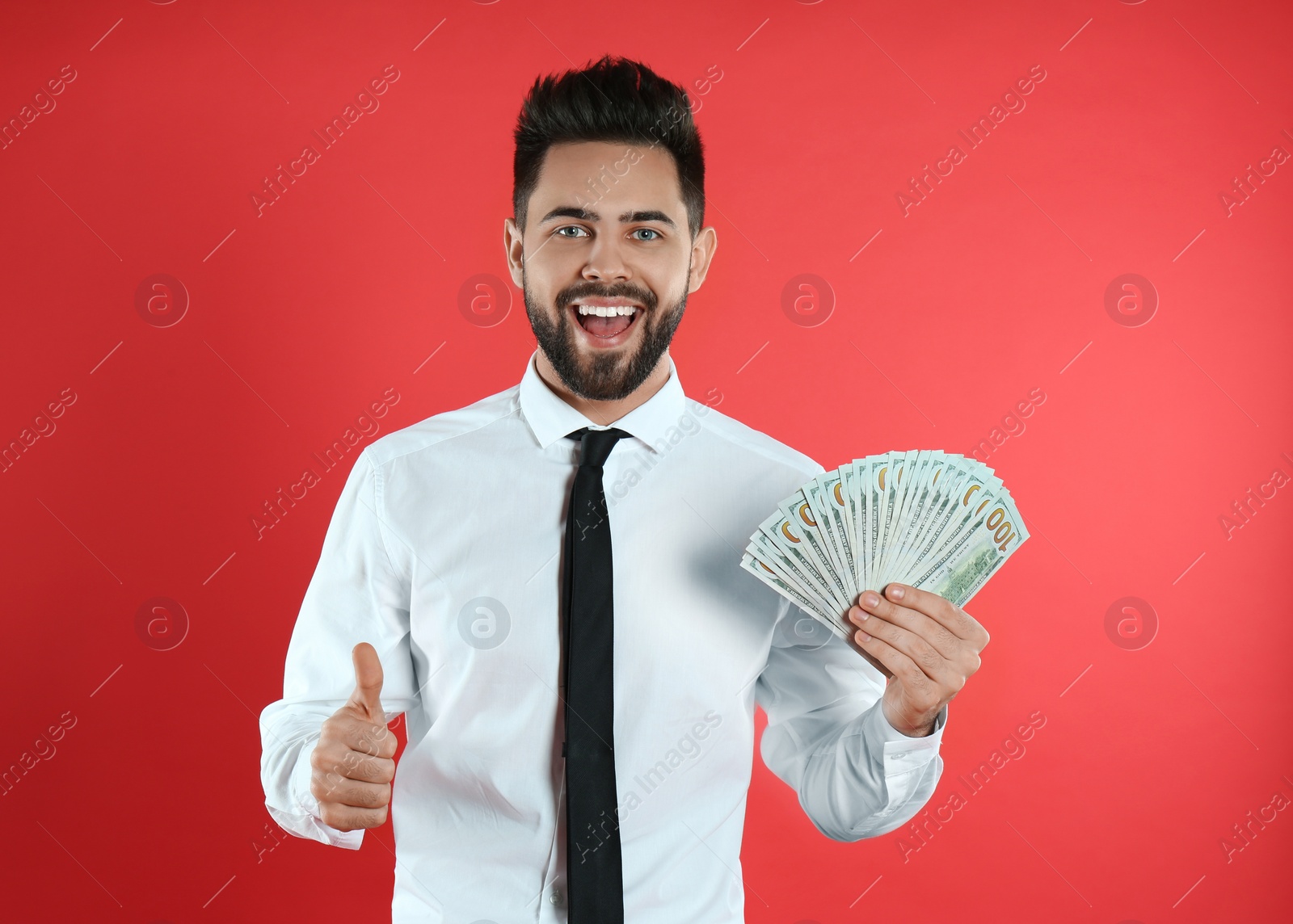 Photo of Emotional young man with money on crimson background