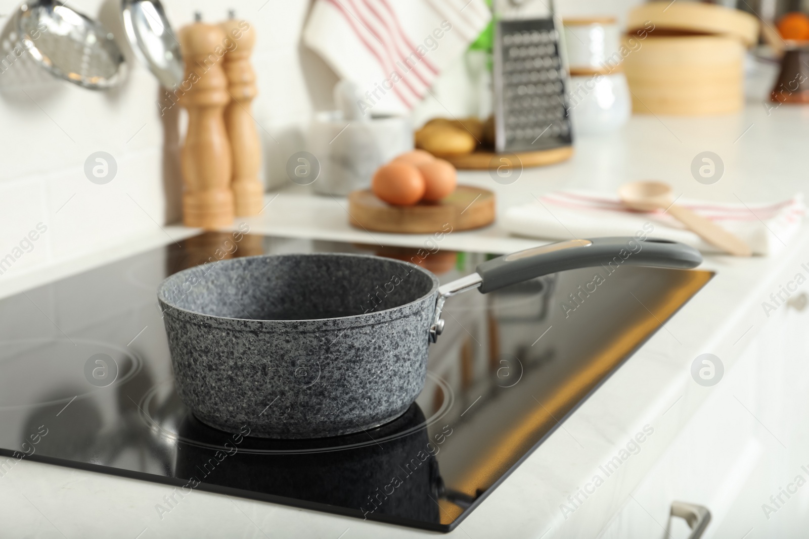 Photo of Saucepan on electric stove in kitchen. Cooking utensil