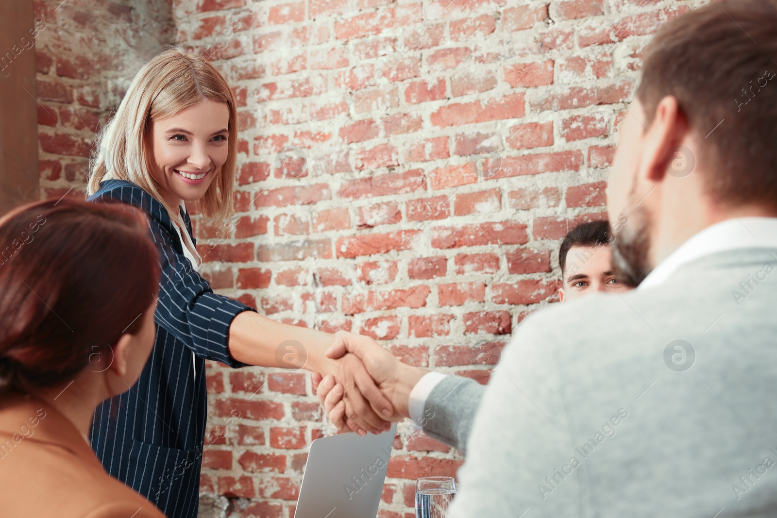 Photo of Businesswoman having meeting with her employees in office. Lady boss