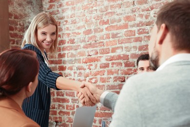 Photo of Businesswoman having meeting with her employees in office. Lady boss