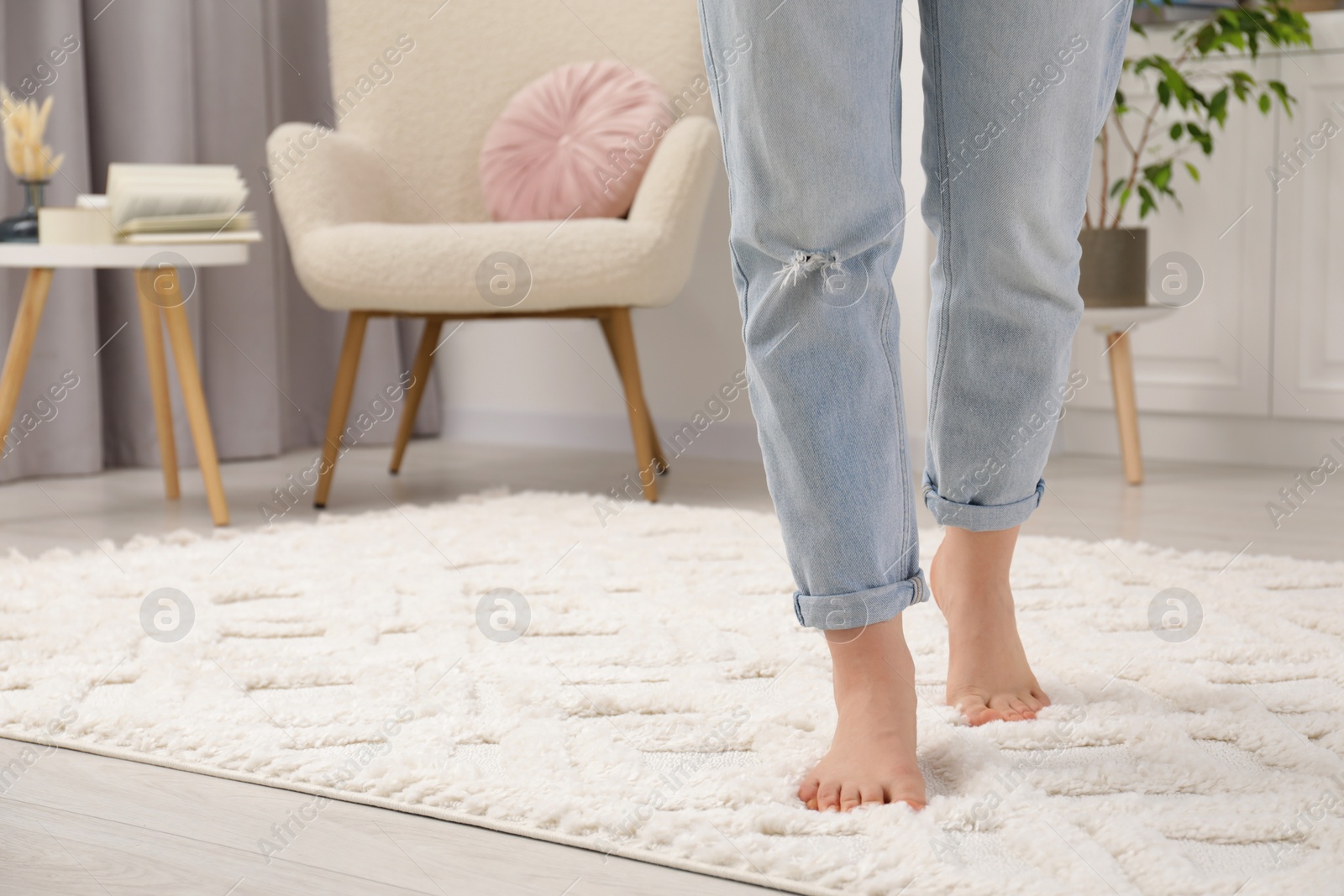 Photo of Woman standing on beige carpet in room, closeup. Space for text