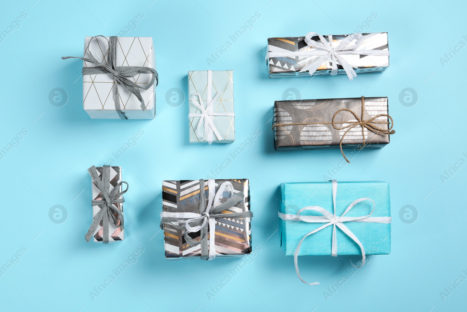 Photo of Flat lay composition with beautiful gift boxes on color background