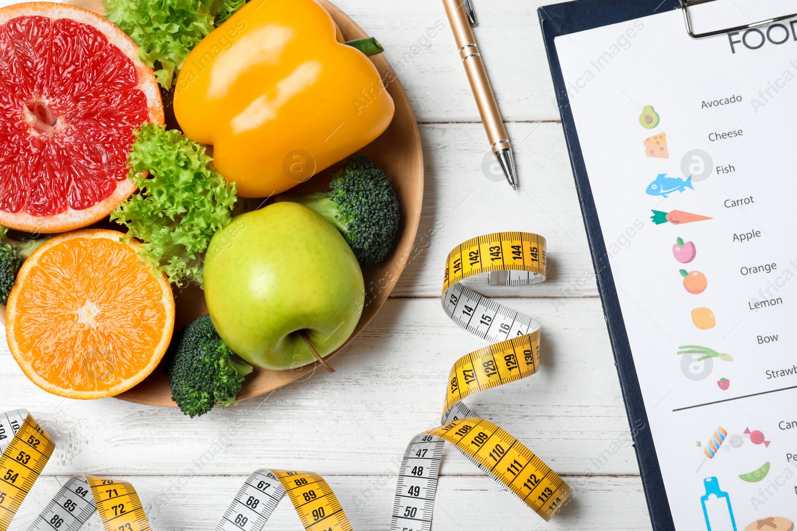 Photo of Fruits, vegetables, measuring tape and list of products on white wooden background, flat lay. Visiting nutritionist