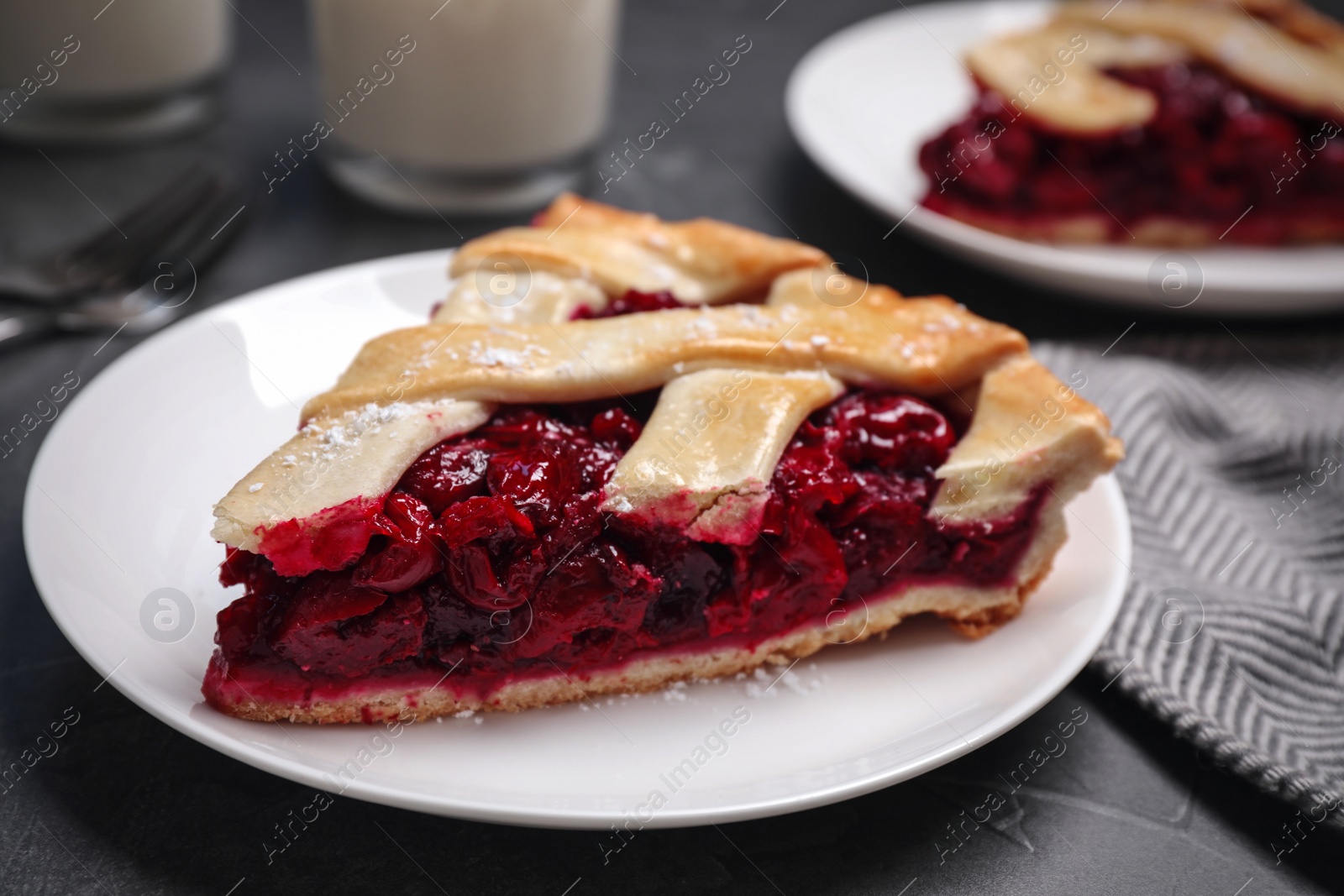 Photo of Slice of delicious fresh cherry pie on table, closeup