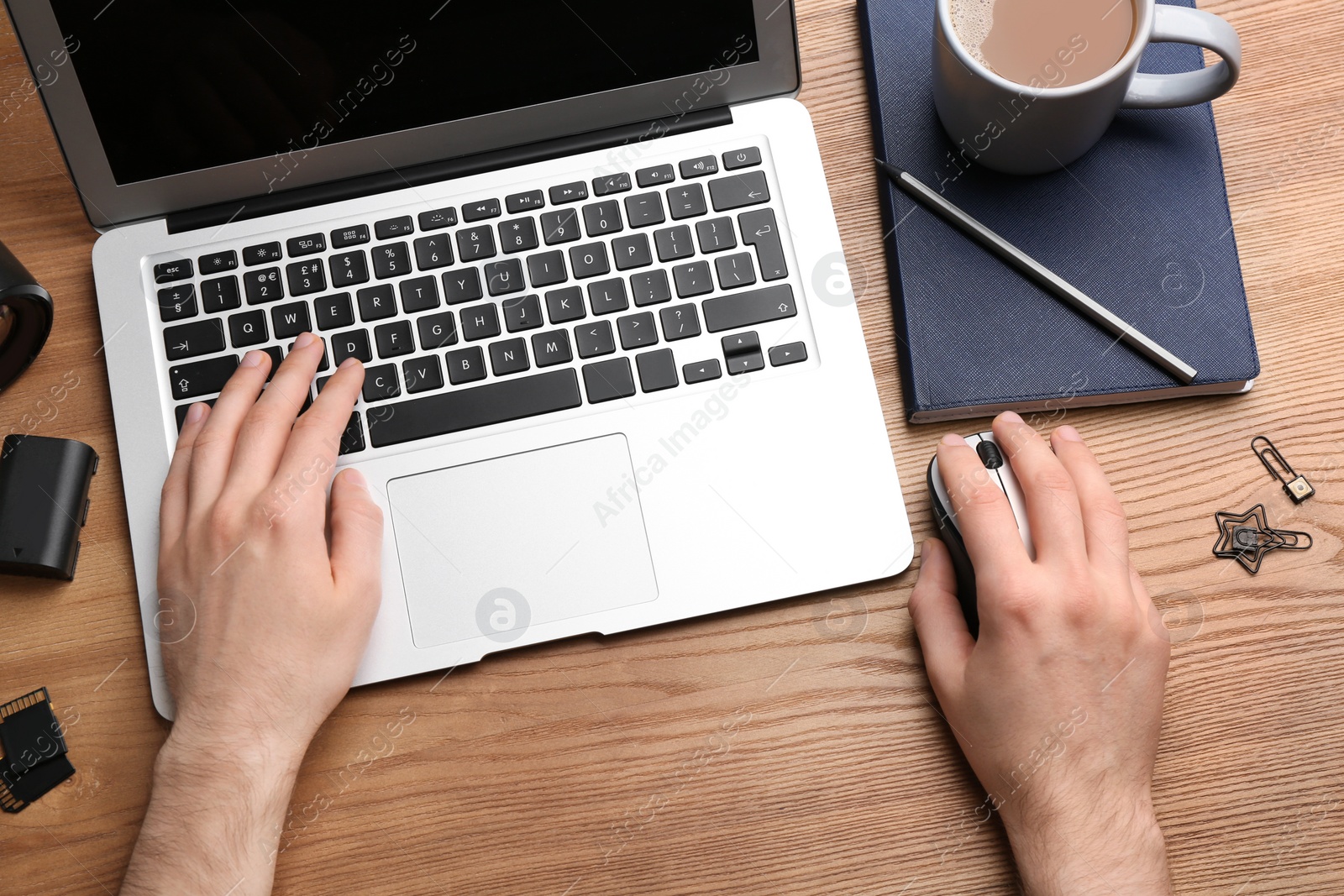 Photo of Man using computer mouse with laptop at office table, top view