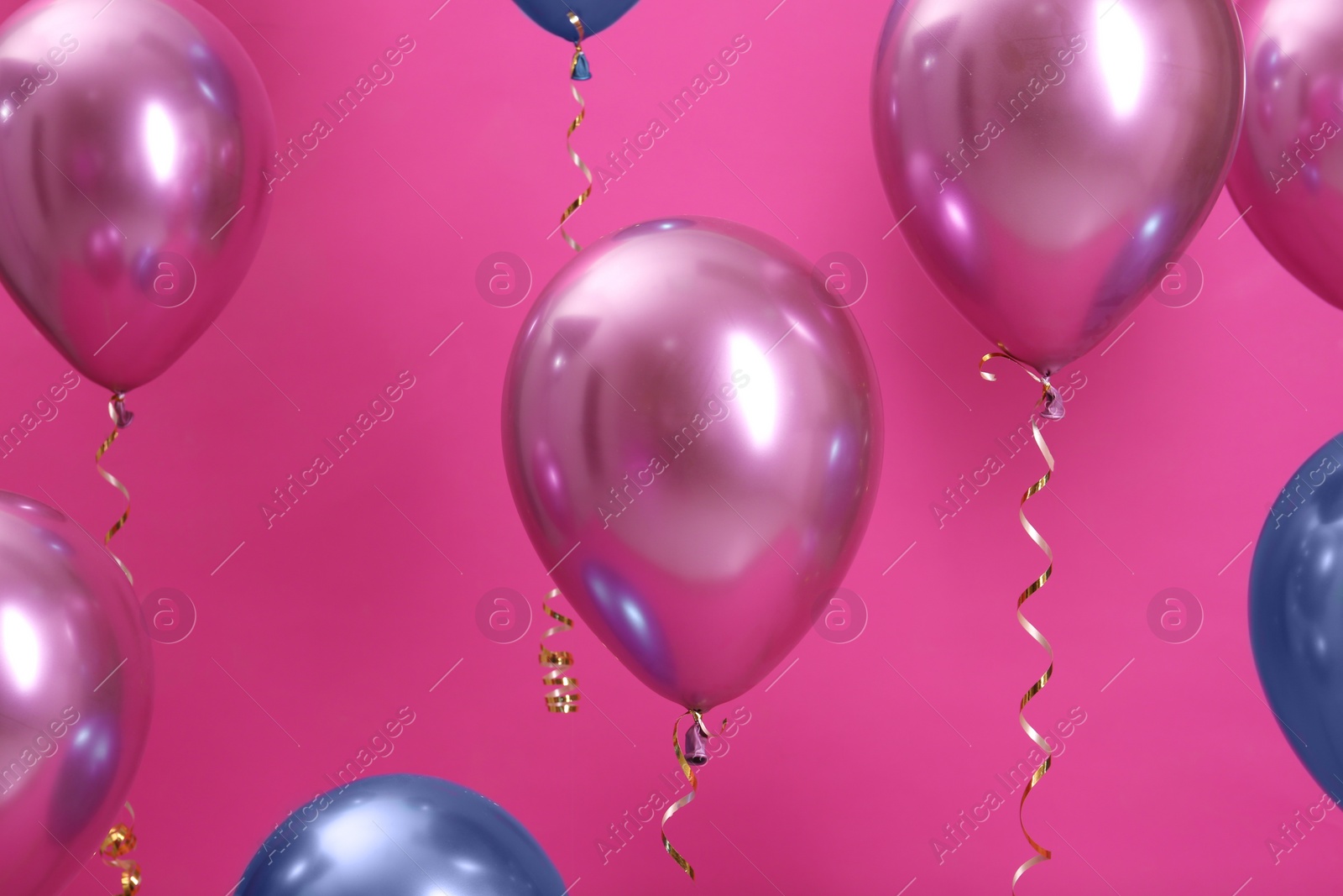 Photo of Bright balloons with ribbons on color background