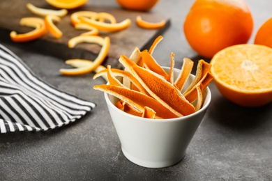 Dry orange fruit peels on grey table