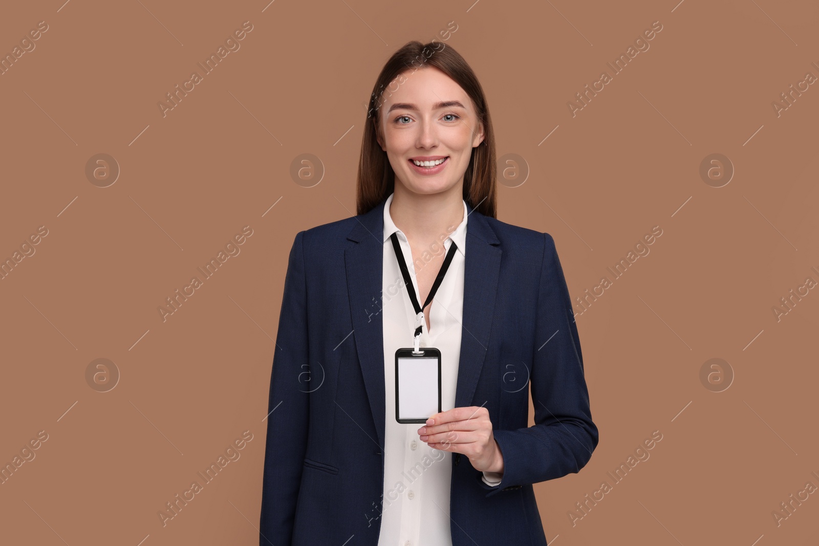 Photo of Woman with blank badge on light brown background