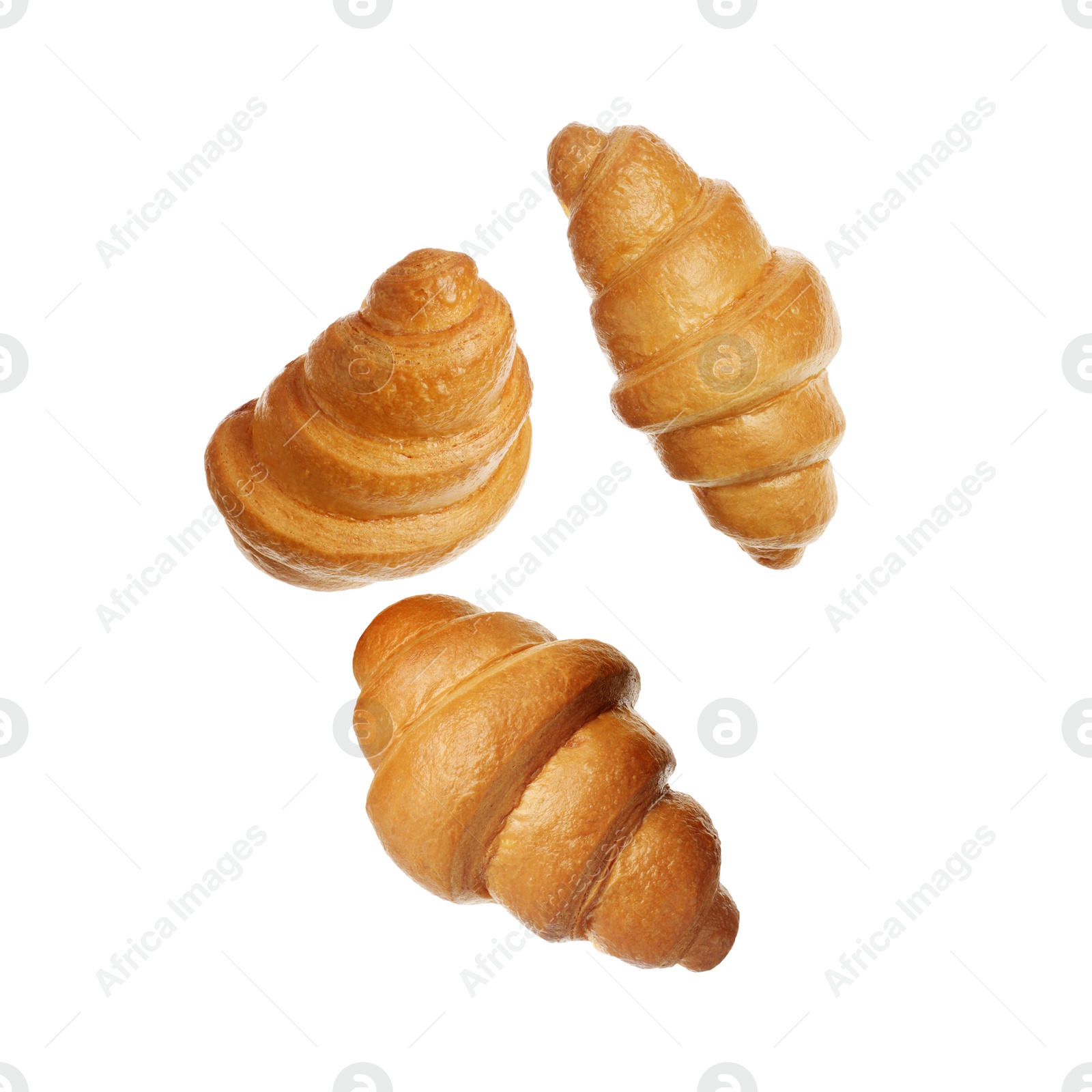 Image of Crusty golden croissants falling on white background