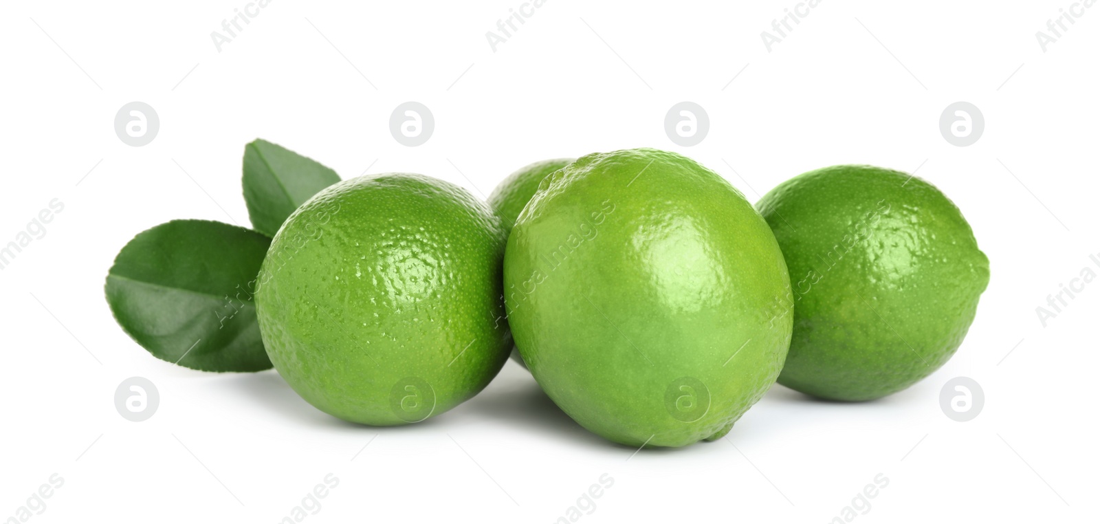 Photo of Fresh ripe limes with green leaves isolated on white