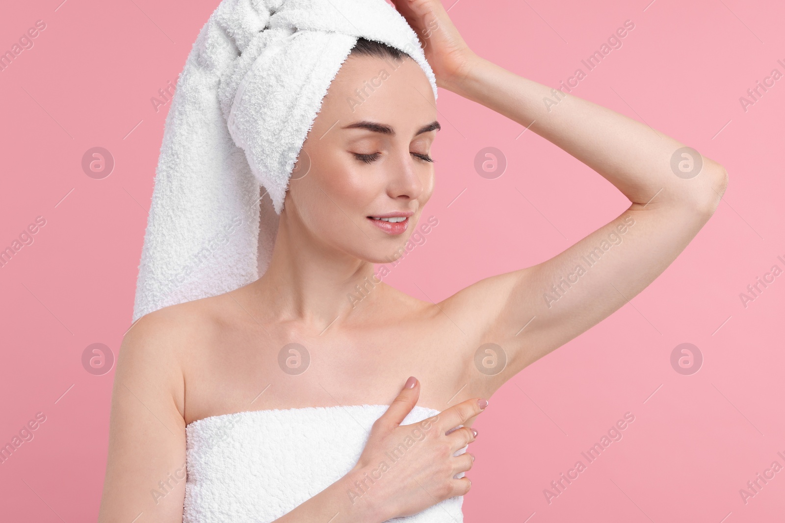 Photo of Beautiful woman showing armpit with smooth clean skin on pink background