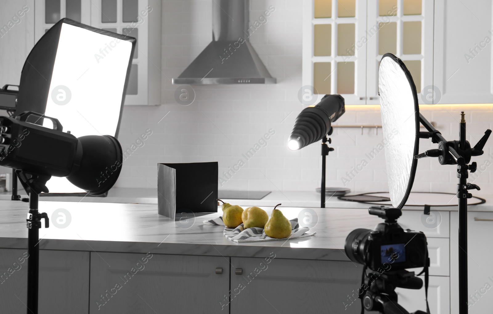 Photo of Professional equipment and many pears on table in kitchen. Food photo