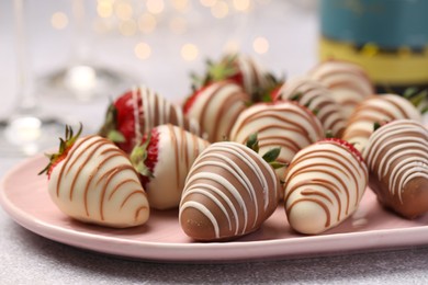 Photo of Delicious chocolate covered strawberries on light table, closeup