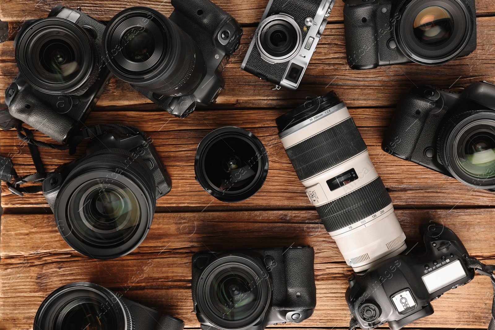 Photo of Modern cameras on wooden table, flat lay