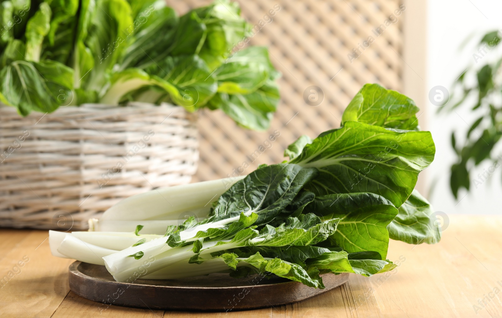 Photo of Leaves of fresh green pak choy cabbage on wooden table