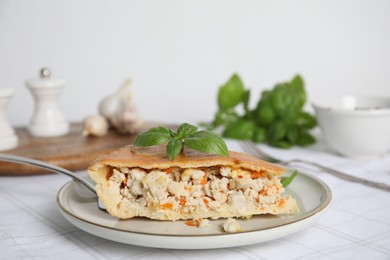 Slice of delicious meat pie with basil on table, space for text